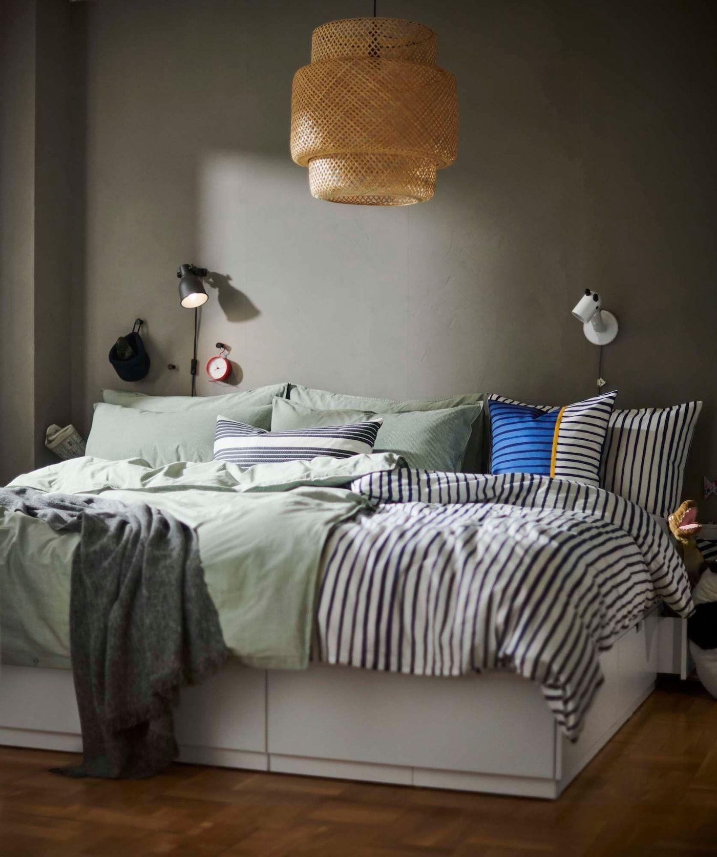 Two single beds are put together and covered with two duvets and lots of pillows.