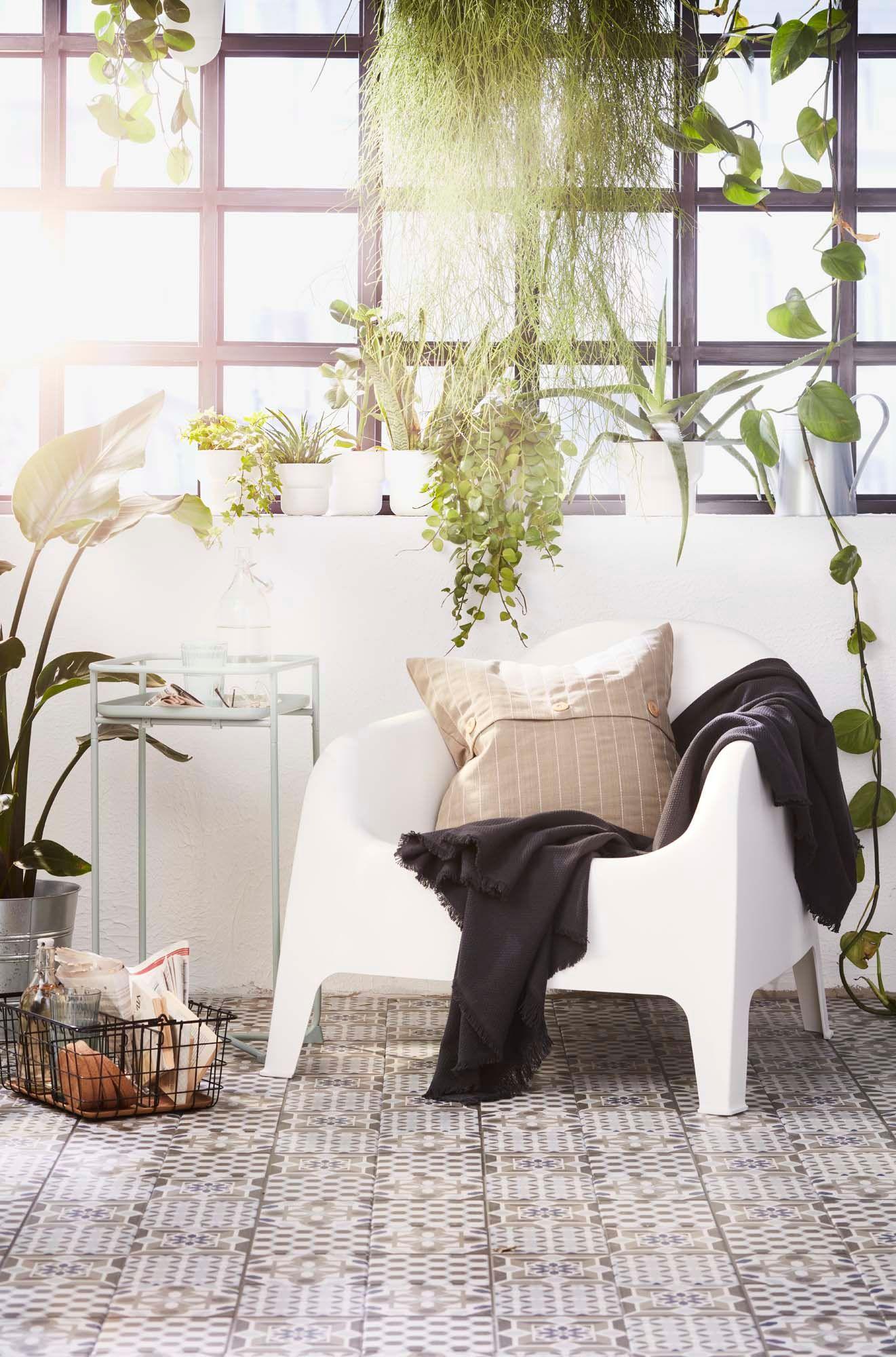 A SKARPÖ chair sits in a room with a tiled floor