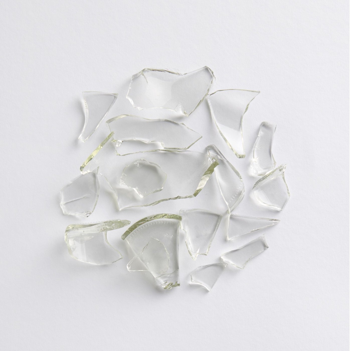 Small pieces of clear glass on a white surface.