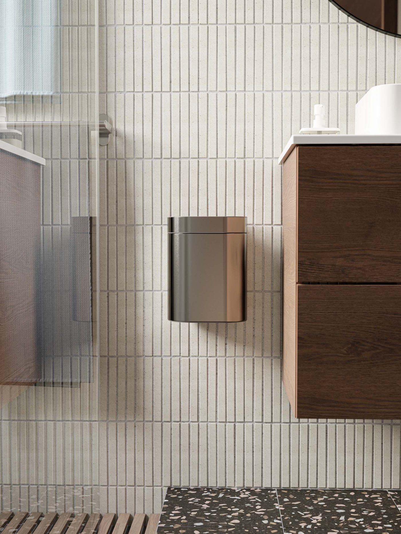 A small wall-hung BROGRUND bin next to a washbasin.