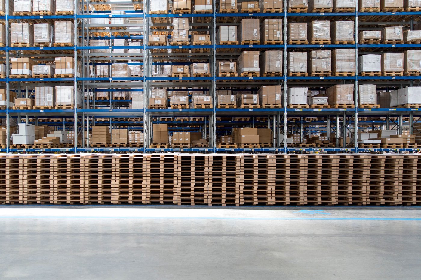 Many goods pallets piled up in a storage environment.