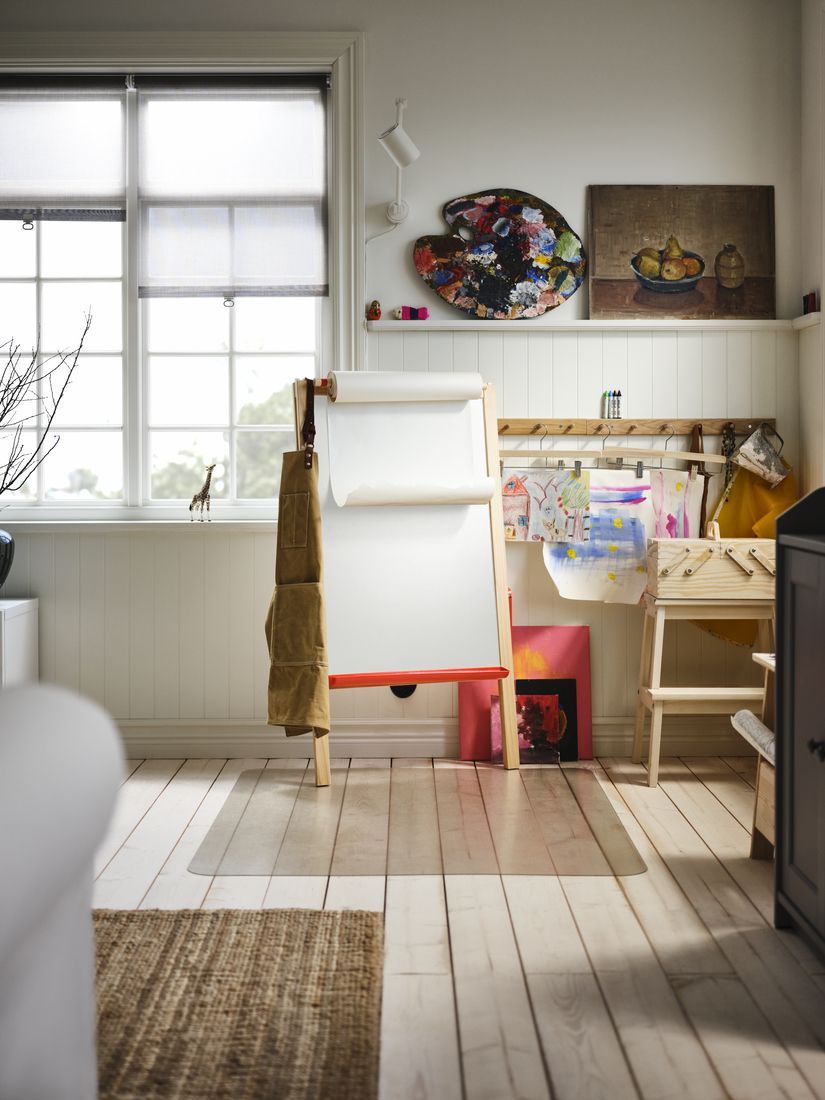A sunny living room corner with a children's arts and crafts zone.