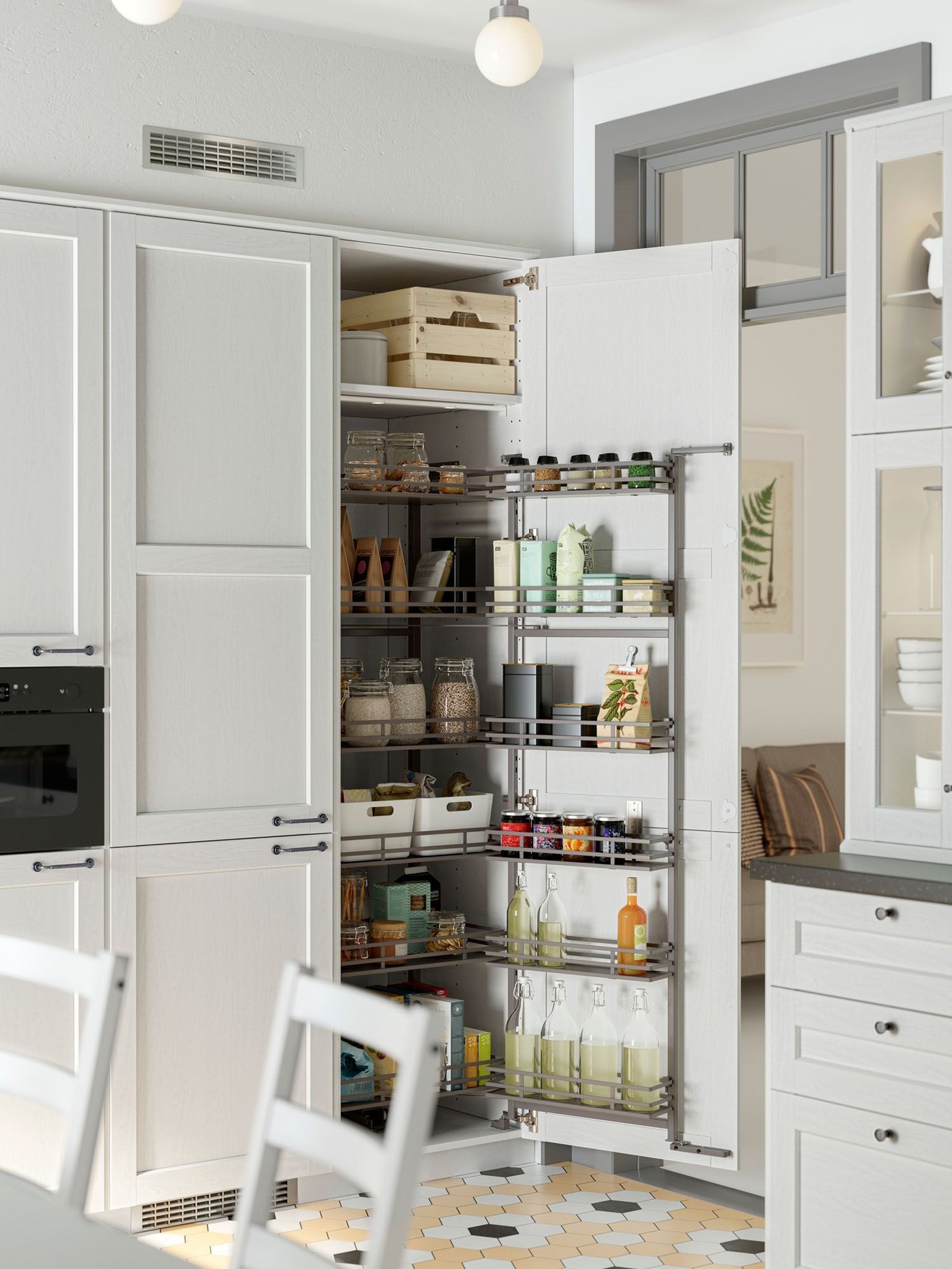 A white kitchen with an open cabinet door revealing an UTRUSTA pull-out larder packed with pantry items.