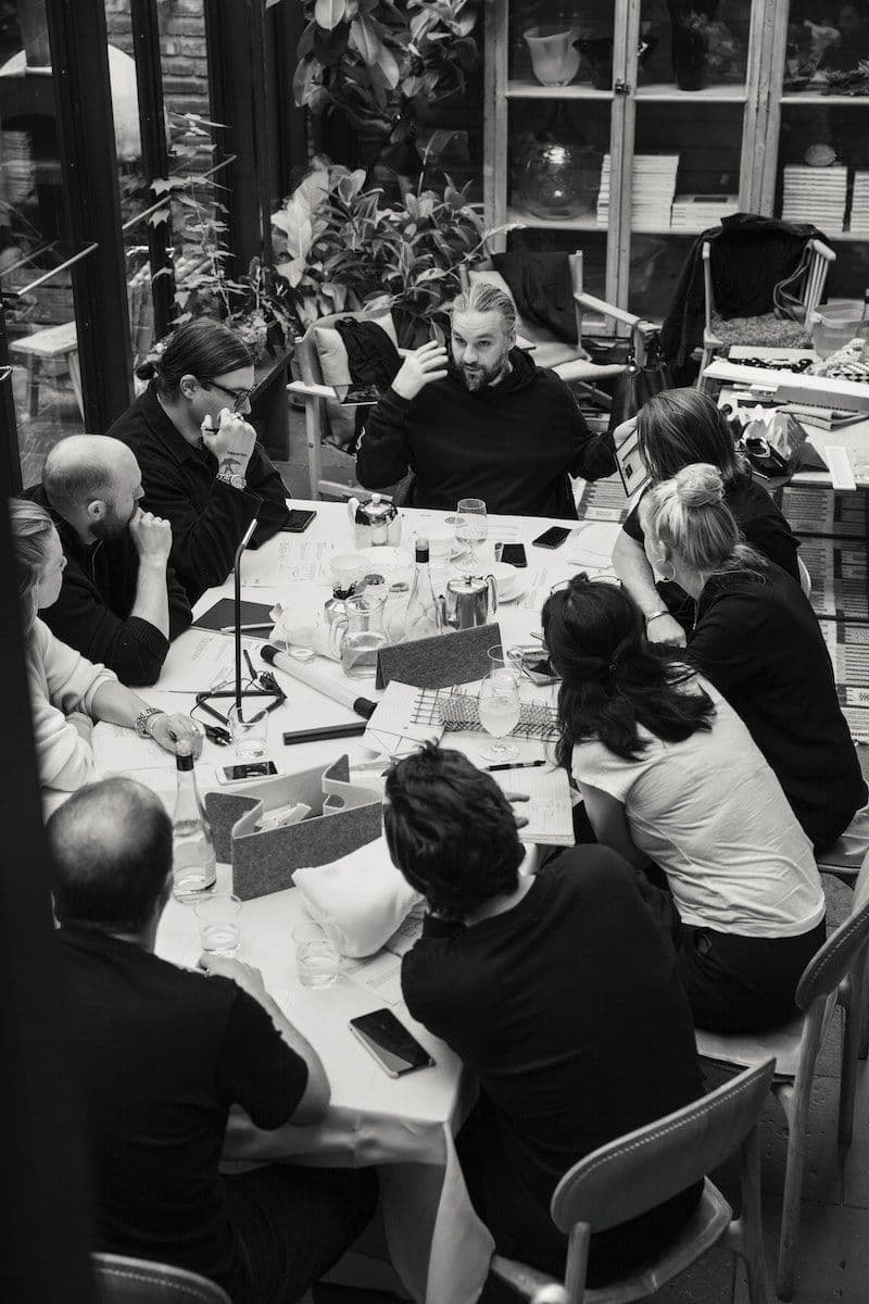 Design team from IKEA and Swedish House Mafia sitting around a large table.