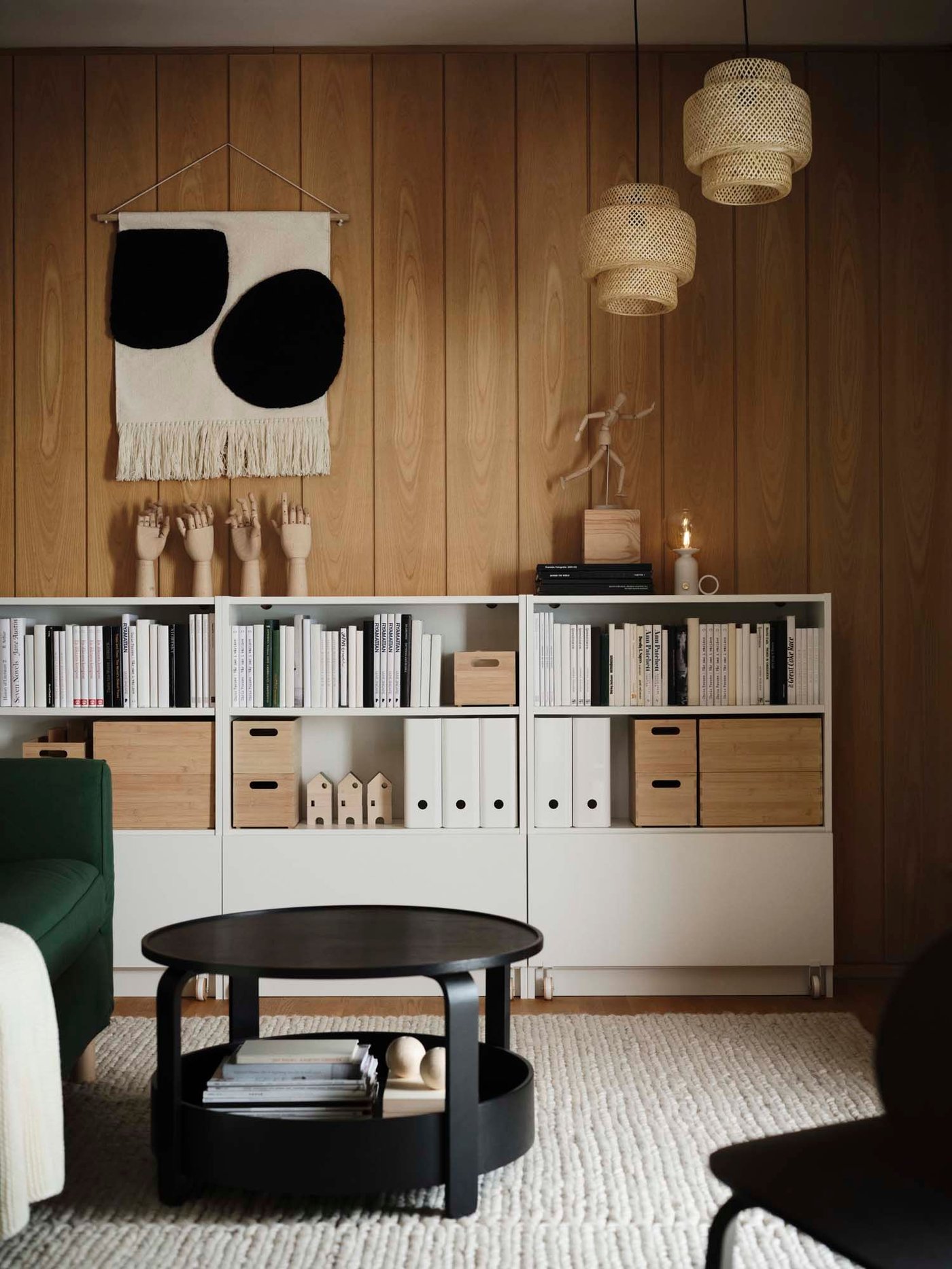 A wood panelled room with a white storage unit filled with files and books.