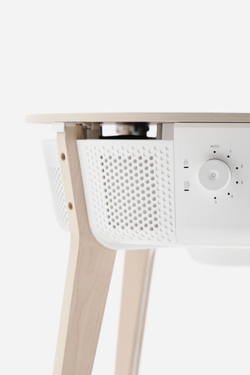 Close up details of the STARKVIND table with air purifier's leg and control panel.