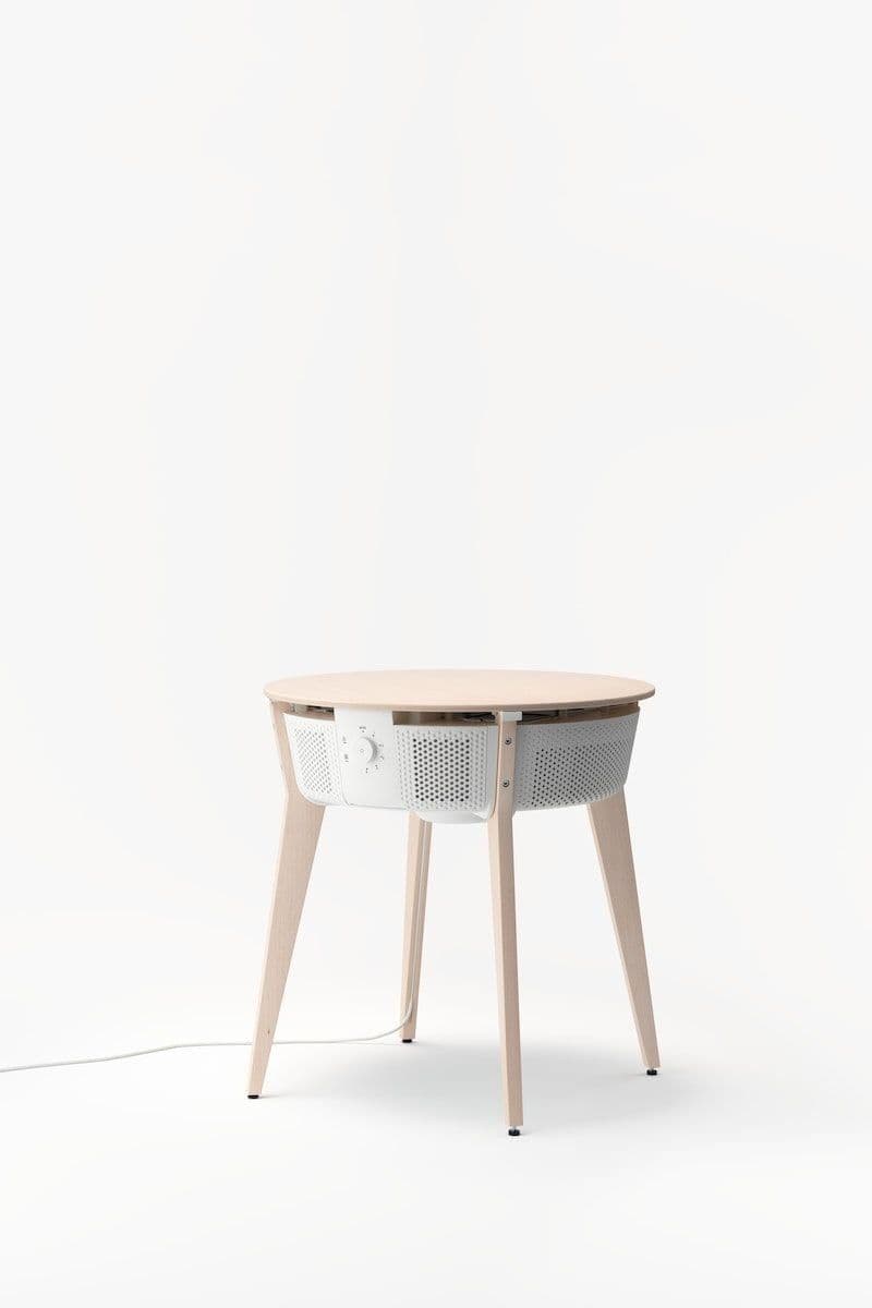 The STARKVIND table with air purifier on a white infinity backdrop.