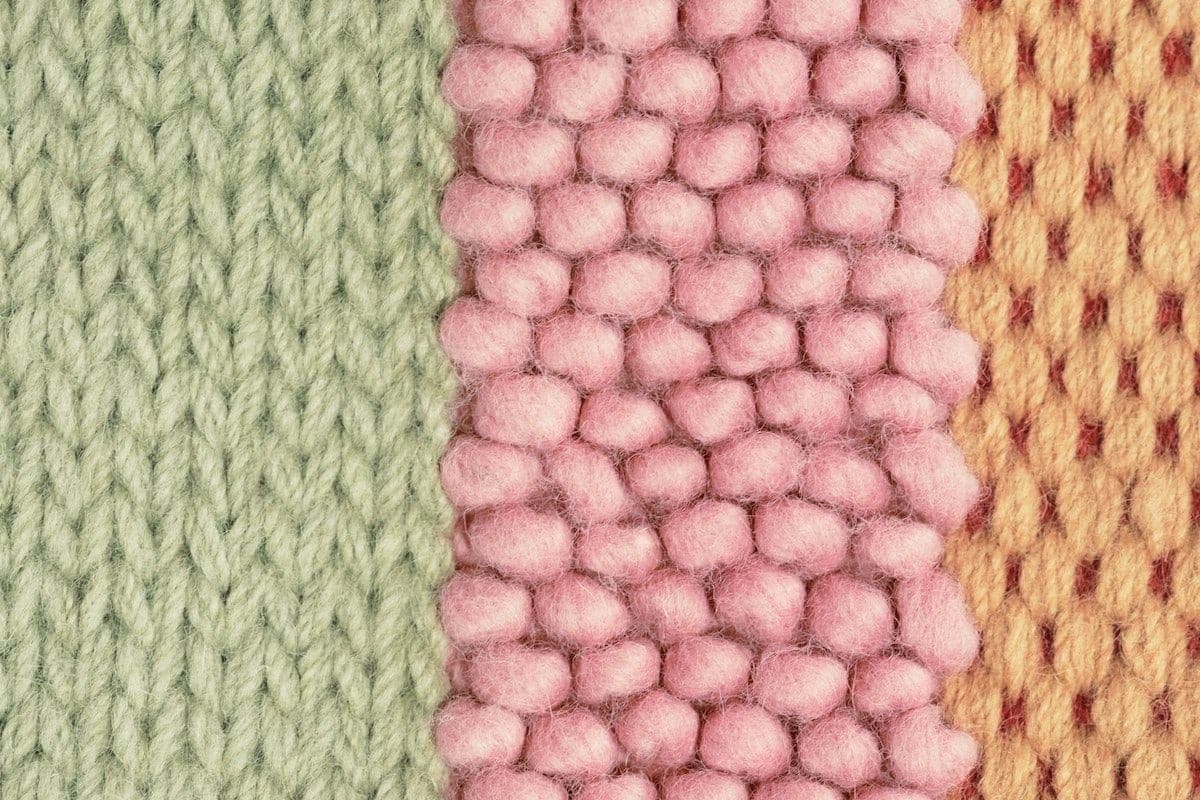 Three different sections of a BRÖNDEN rug, woven in different techniques in green, pink and orange.