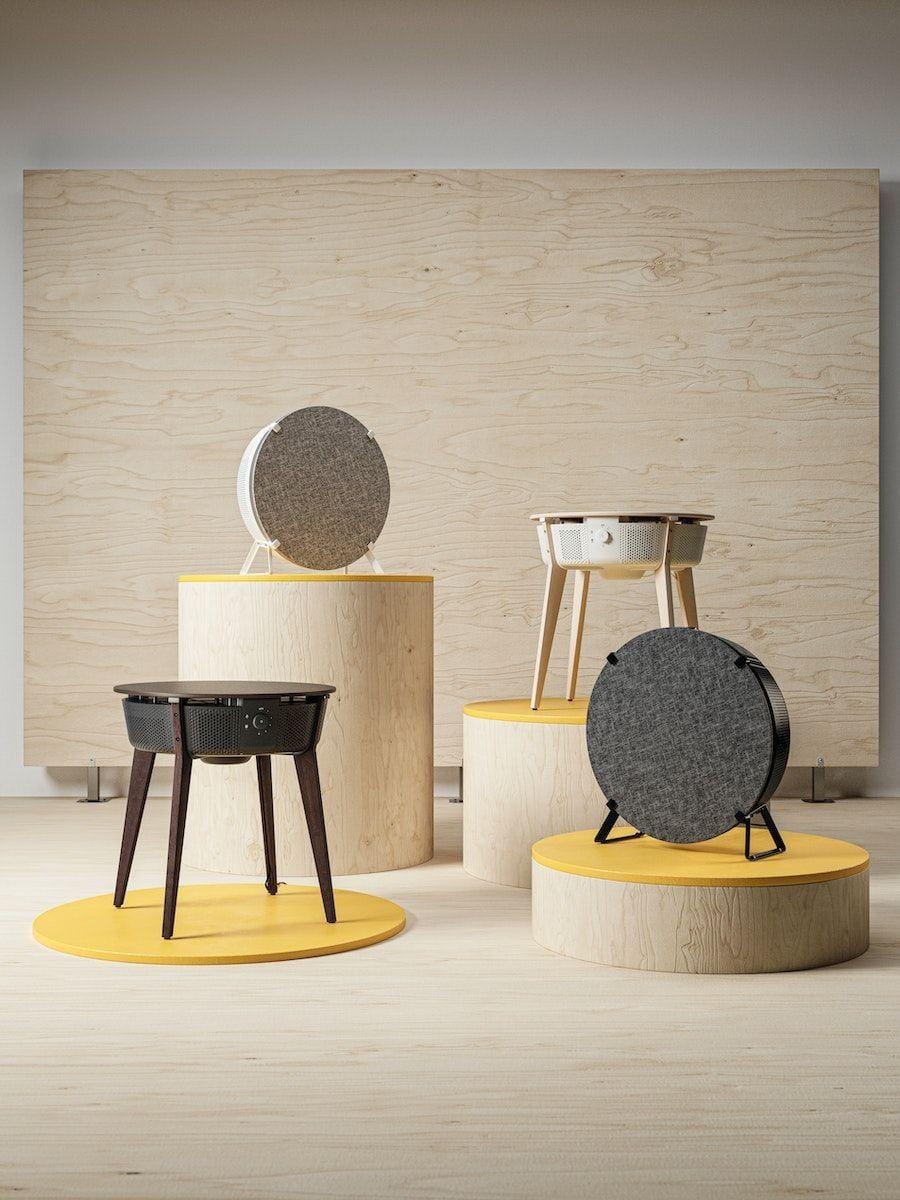 The full range of STARKVIND air purifiers, displayed on light wood plinths.