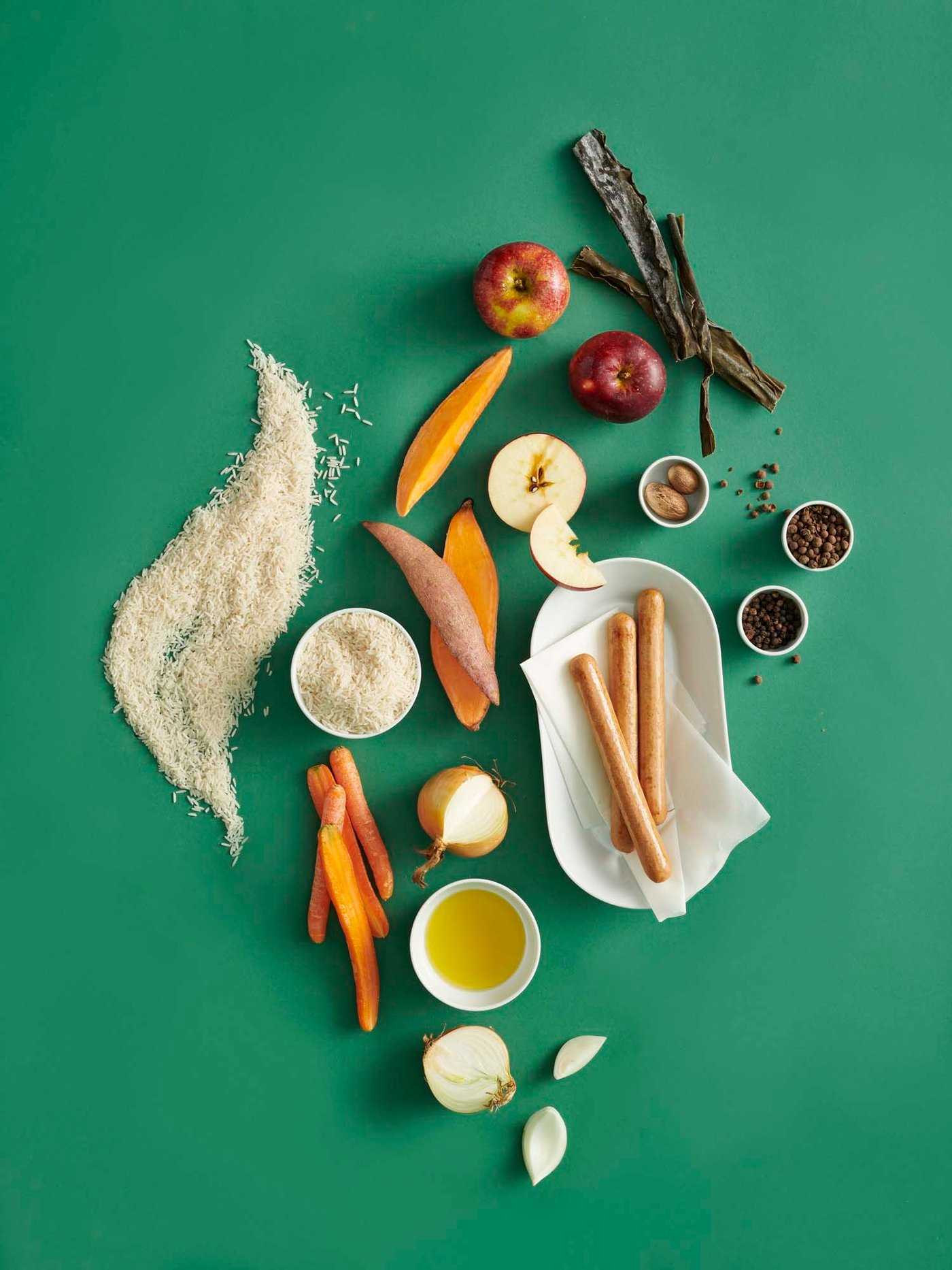 Vegetables and other ingredients on a green background.