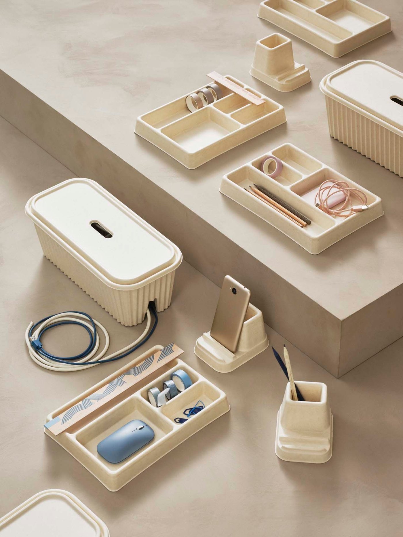 A collection of HÖNSNÄTT desk tidy accessories on a light wood surface.