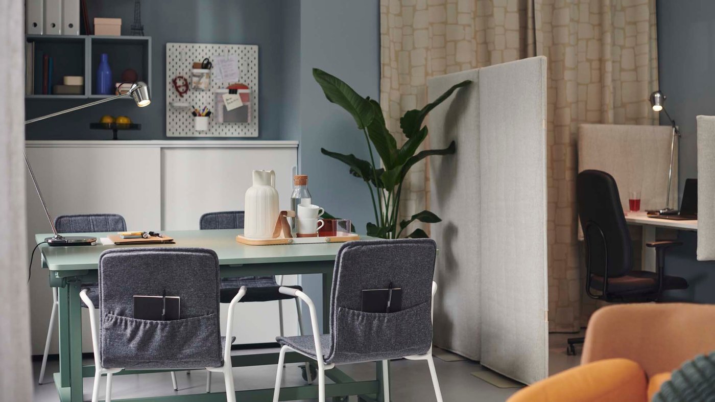 An open-plan office space divided by a MITTZON acoustic screen, floor standing.