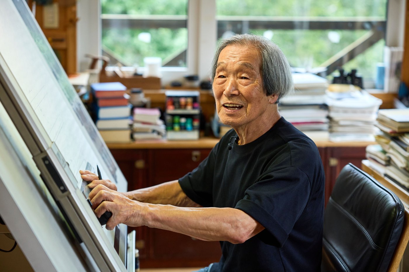 Noboru Nakamura is standing in his workshop wearing a black t-shirt.