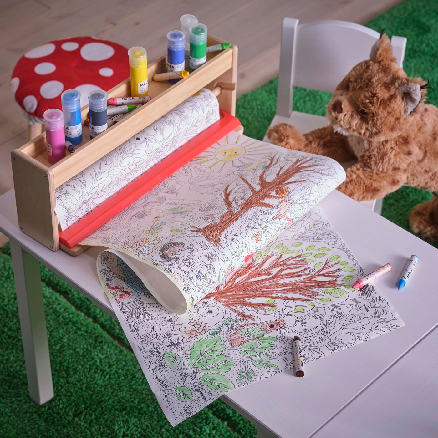 A roll of forest-themed colouring paper which has been half coloured in.