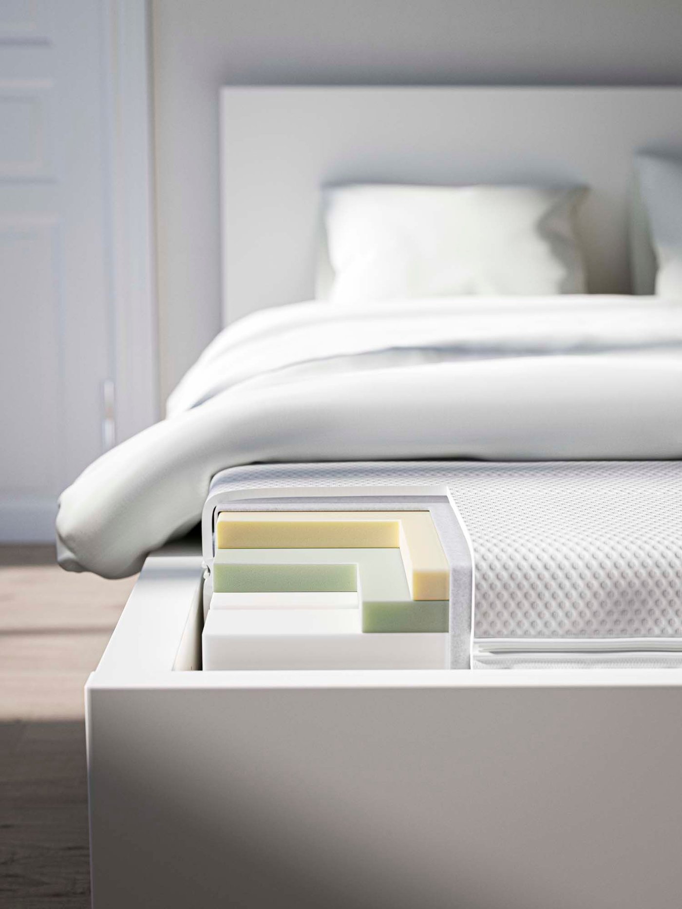 A bed with parts of the mattress cut out revealing the different layers.