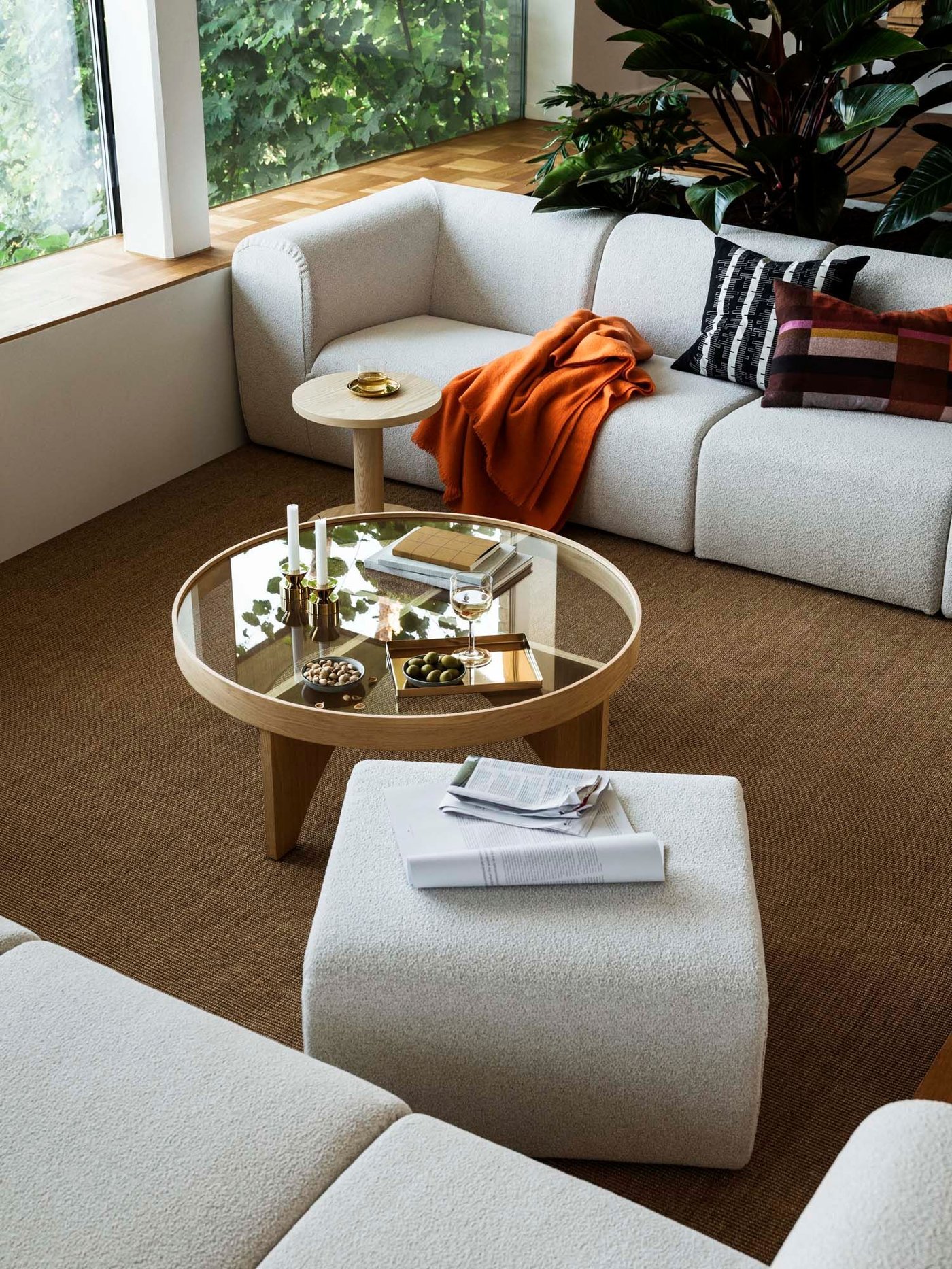 An aerial view of grey sofas, a matching footstool and a glass-topped coffee table from the STOCKHOLM 2025 collection.