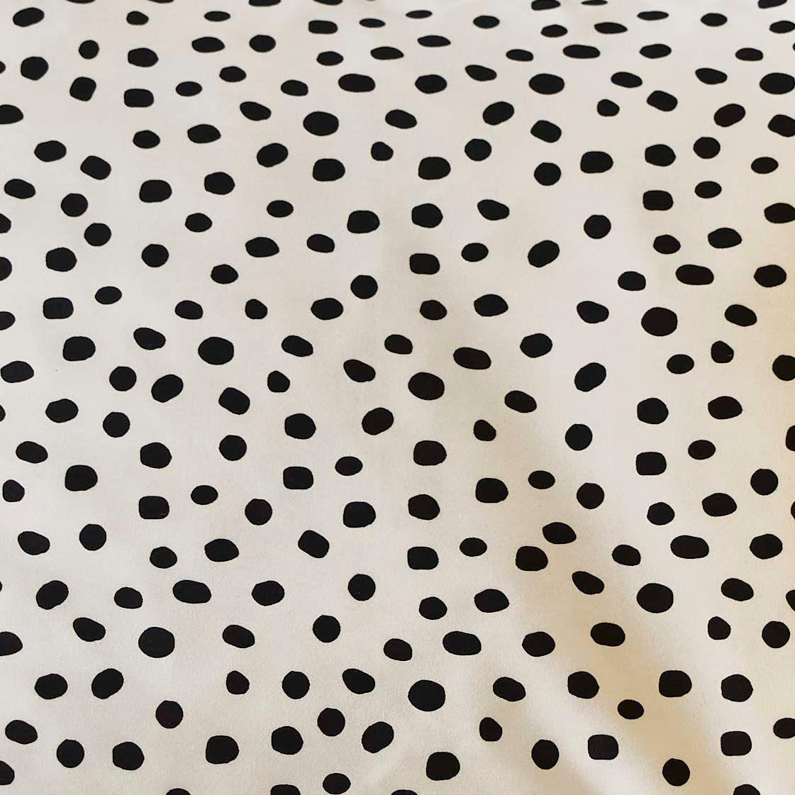 A close-up of a black and white spot duvet cover.