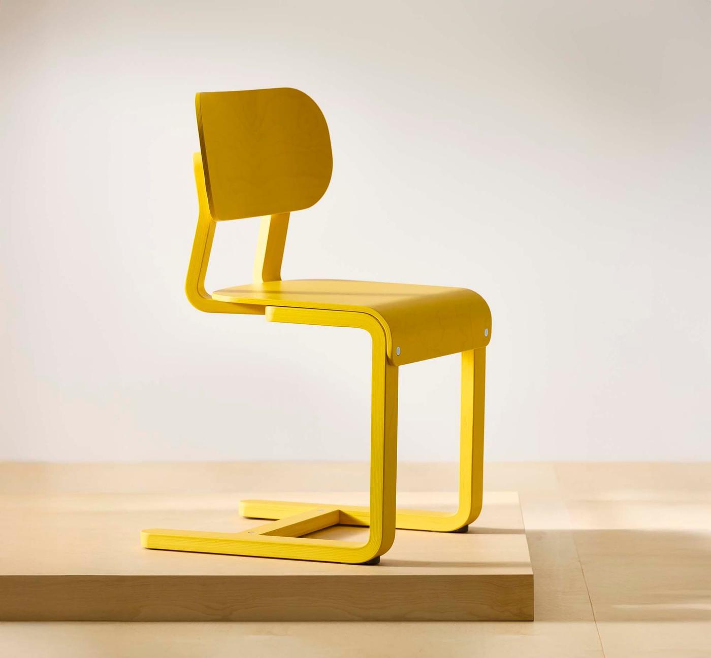 A side view of a yellow LYCKAN chair.