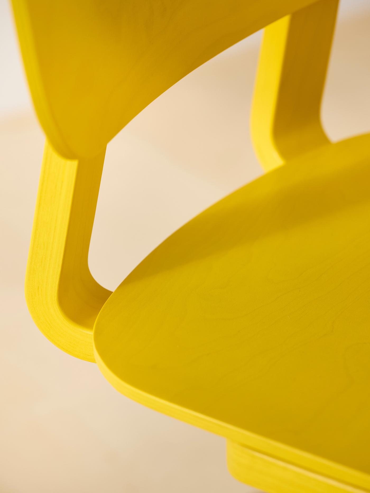A closeup of the seat of a yellow LYCKAN chair.