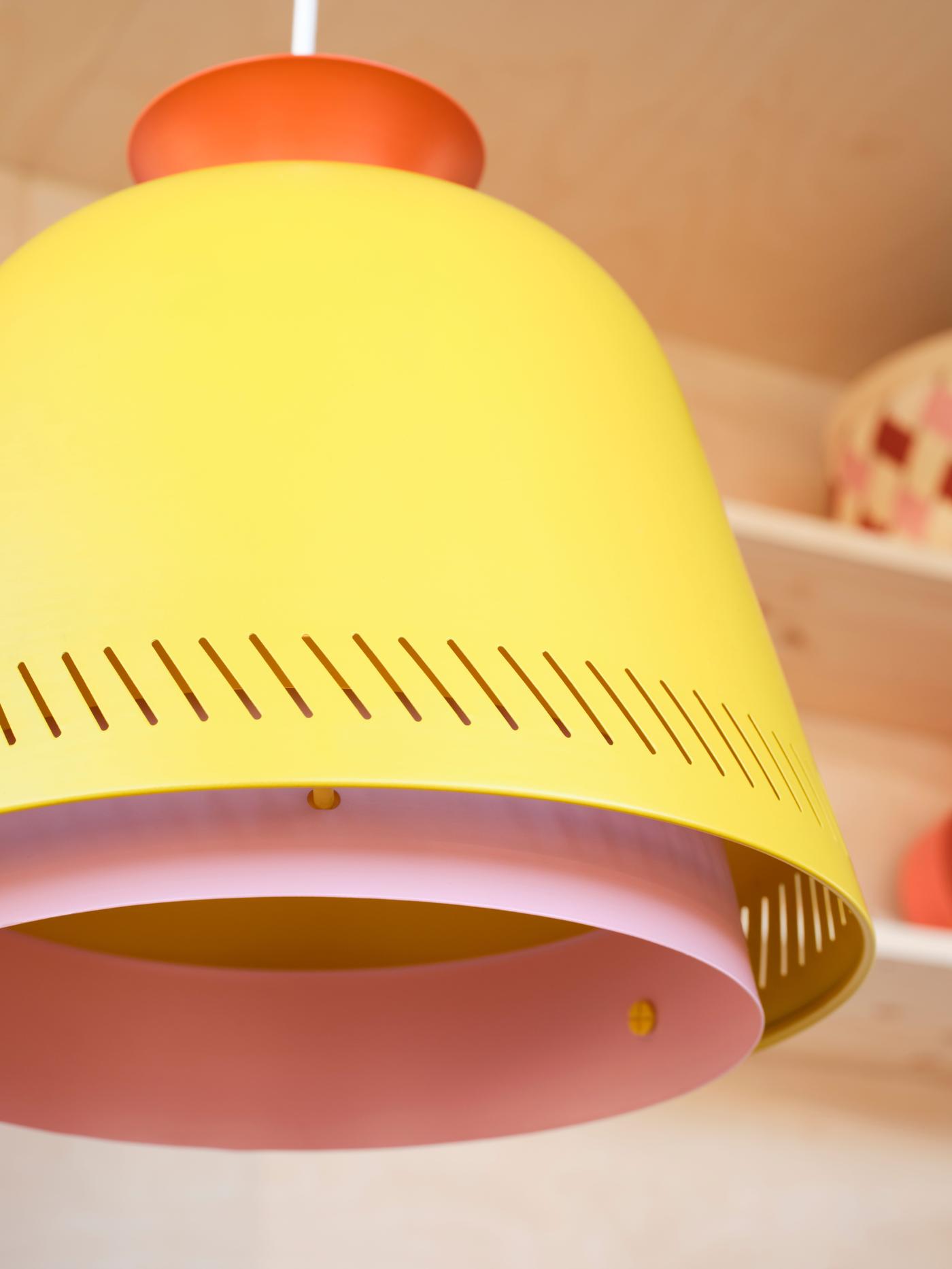 Close-up of a yellow, pink and orange pendant lamp.