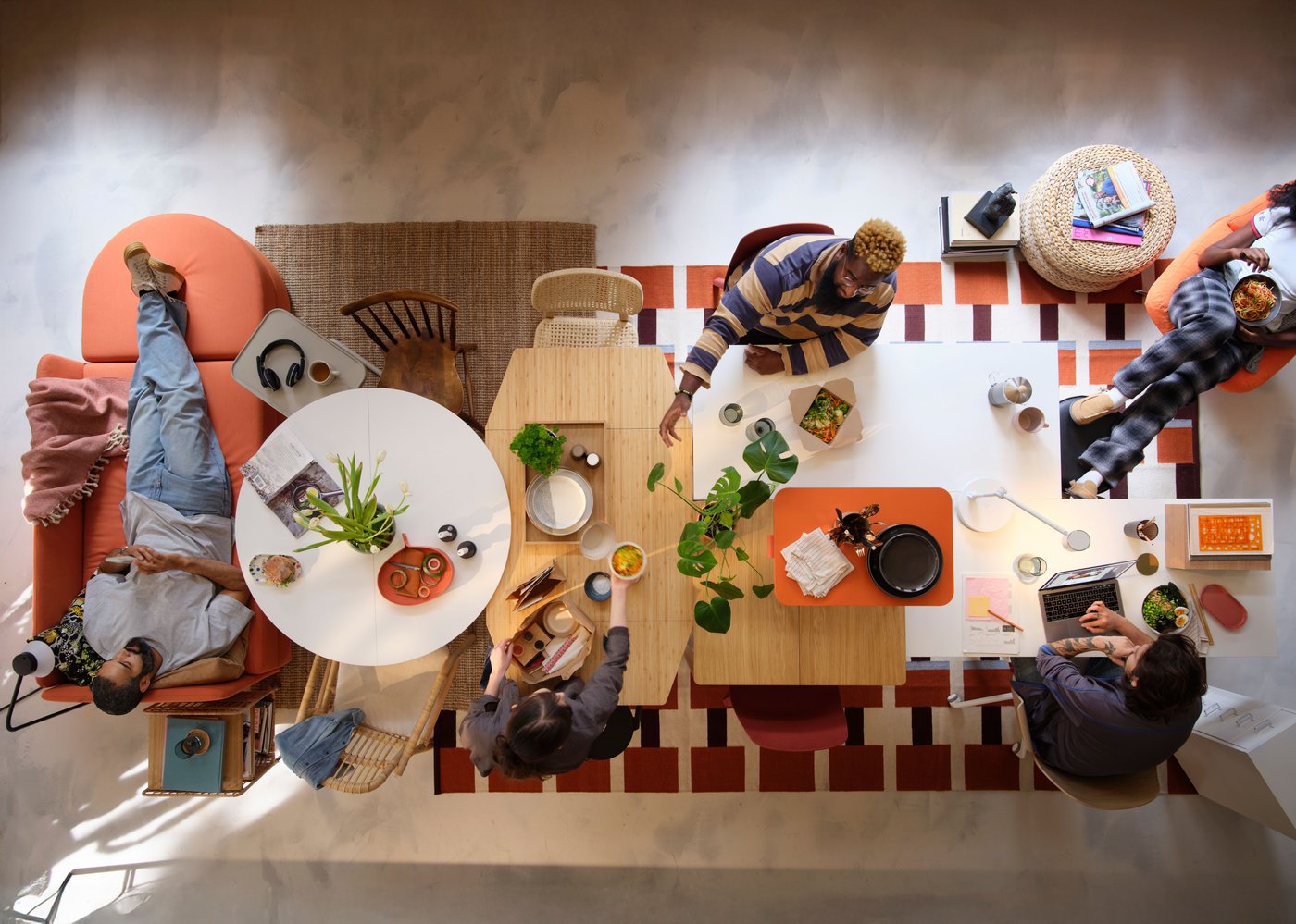 A group of people is sitting at a dining table and enjoying different activities, including eating.
