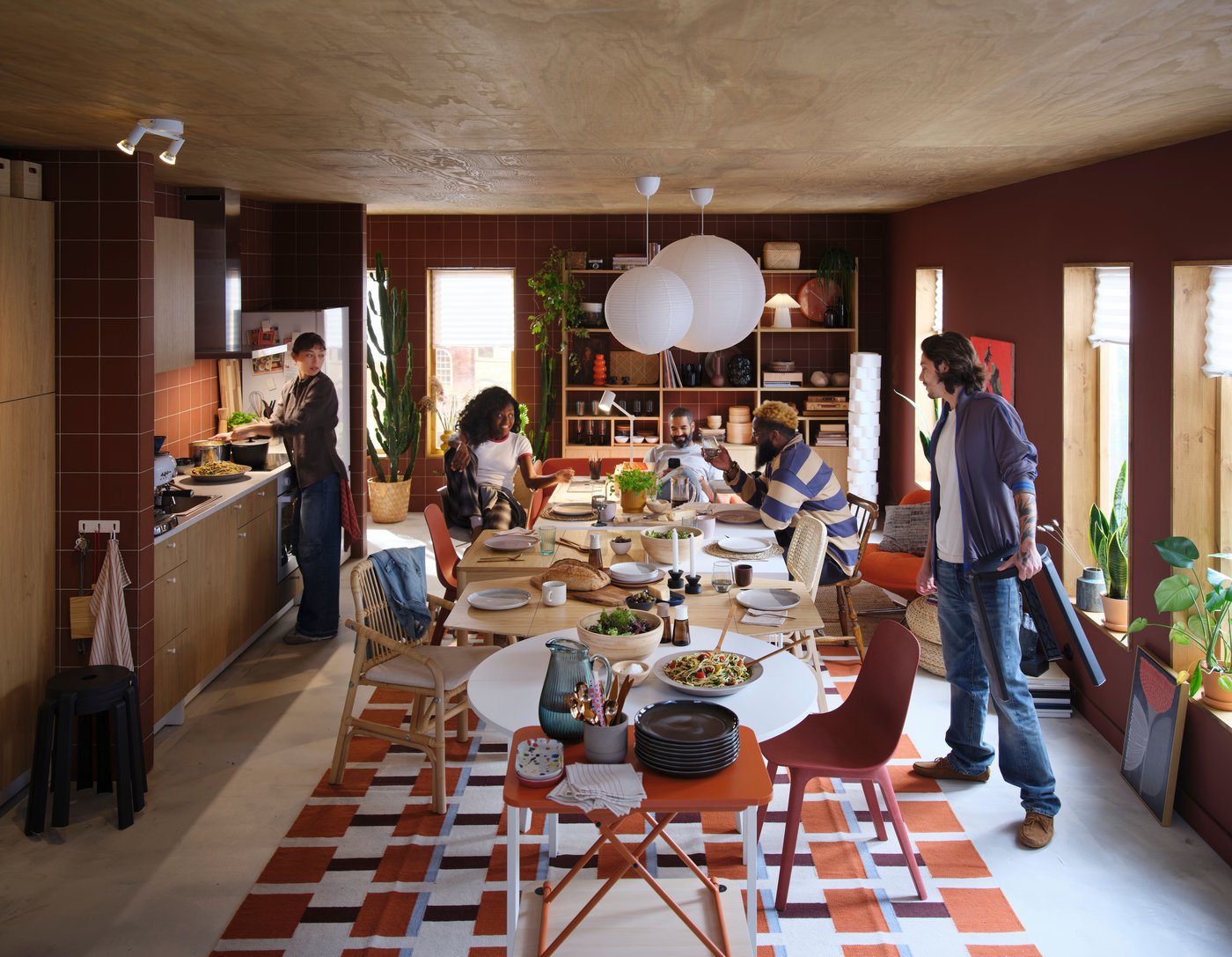 A group of people is sitting at a dining table and enjoying different activities, including eating.