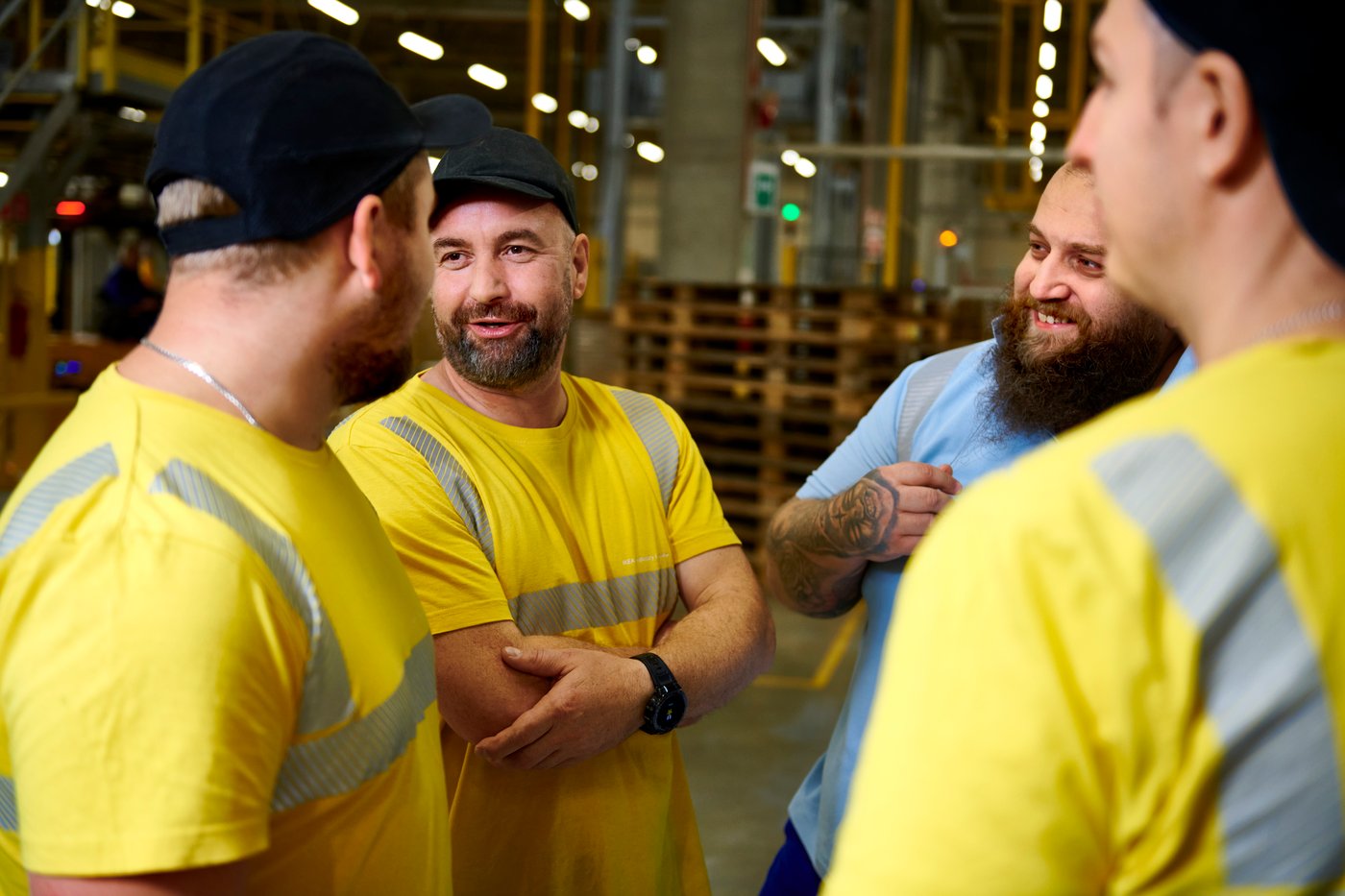 Co-workers talk amongst themselves onsite in Lubawa.