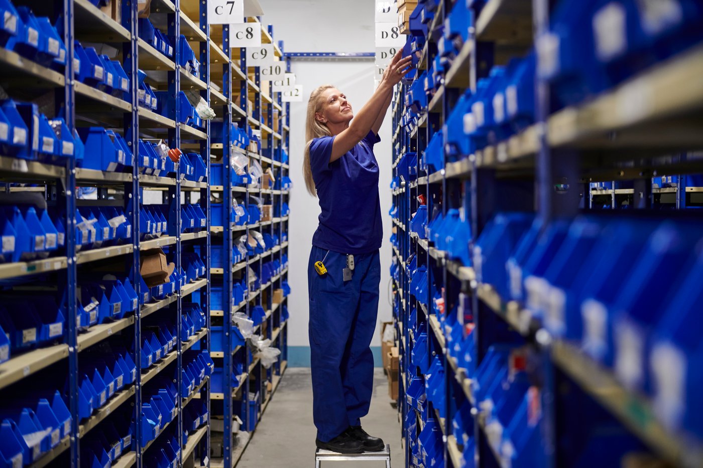 A person working between aisles on an IKEA industry site in Poland.