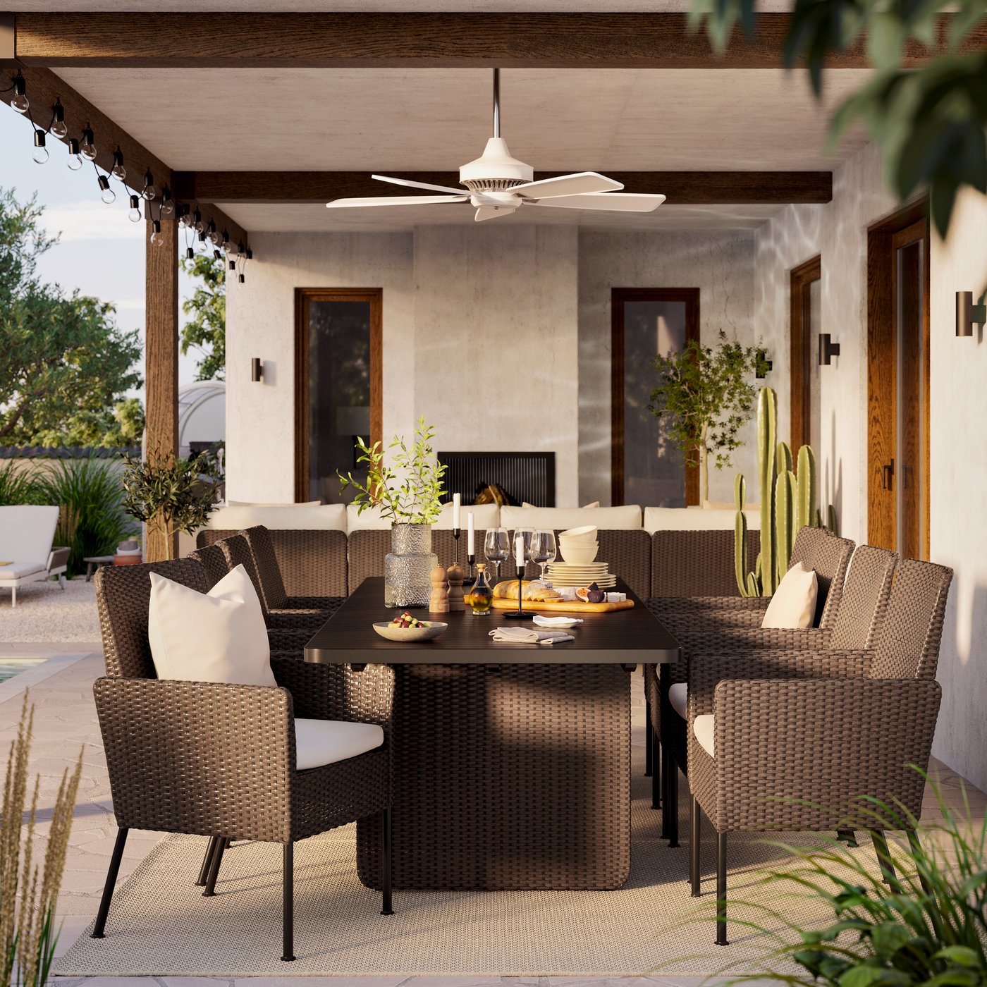 An outdoor dining area with a roof, a dark brown dining room set and a fan above the table.
