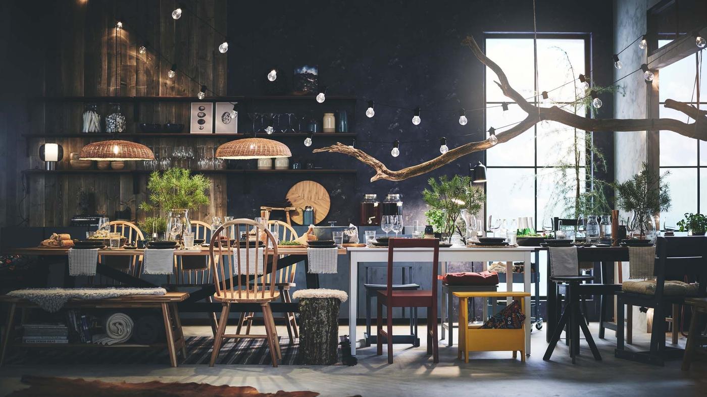 A dining room with a long table and lots of chairs. The table is set, ready for a large gathering.