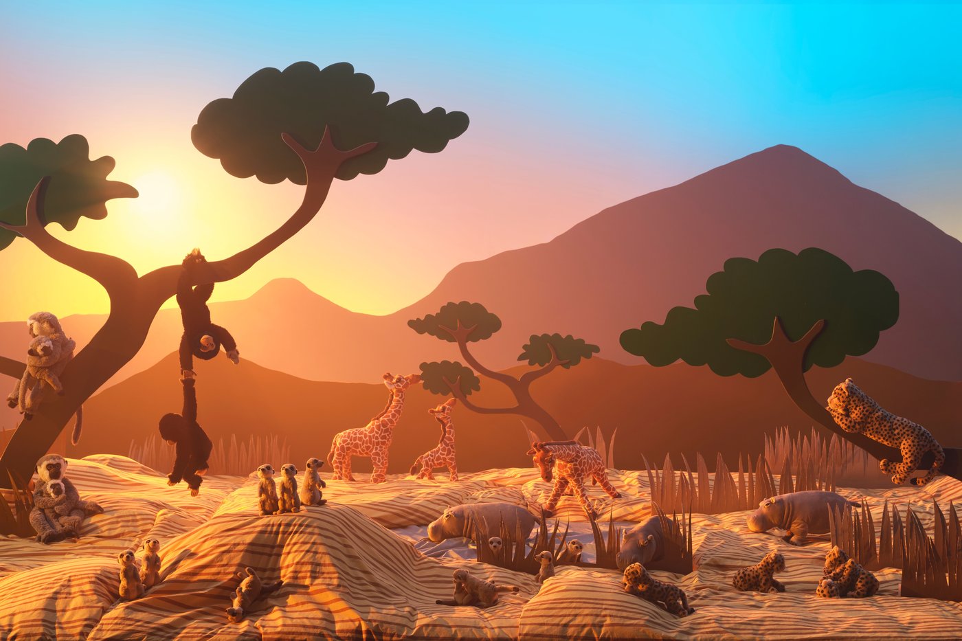 Several different soft toys of which monkeys, giraffes and meercats, all displayed with a backdrop inspired by the African Savannah.