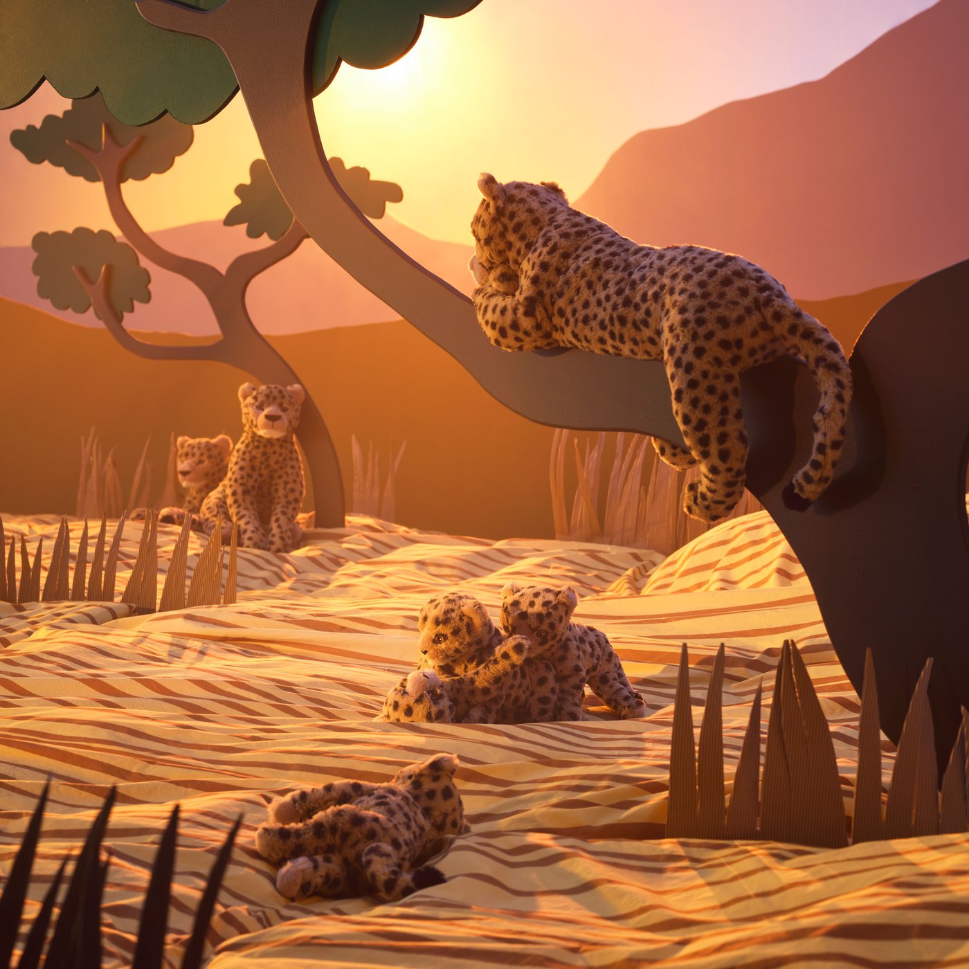 Several different cheetah soft toys, all displayed with a backdrop inspired by the African Savannah.