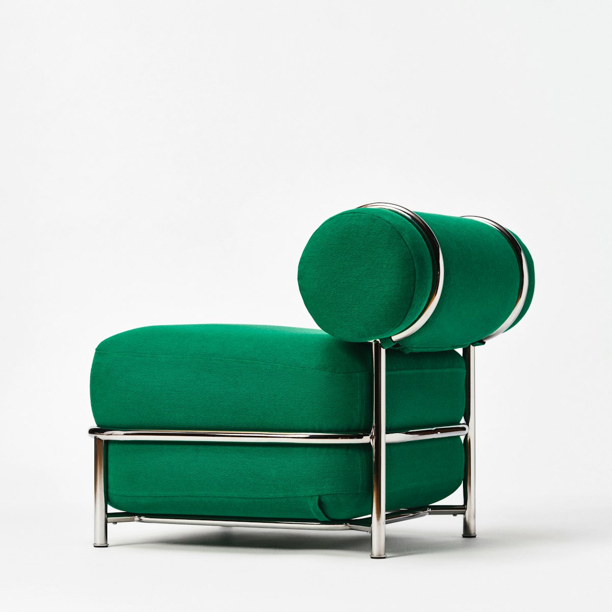 Green air-filled upholstered lounge chair with cylindrical back cushions and a polished metal frame, photographed against a white background.