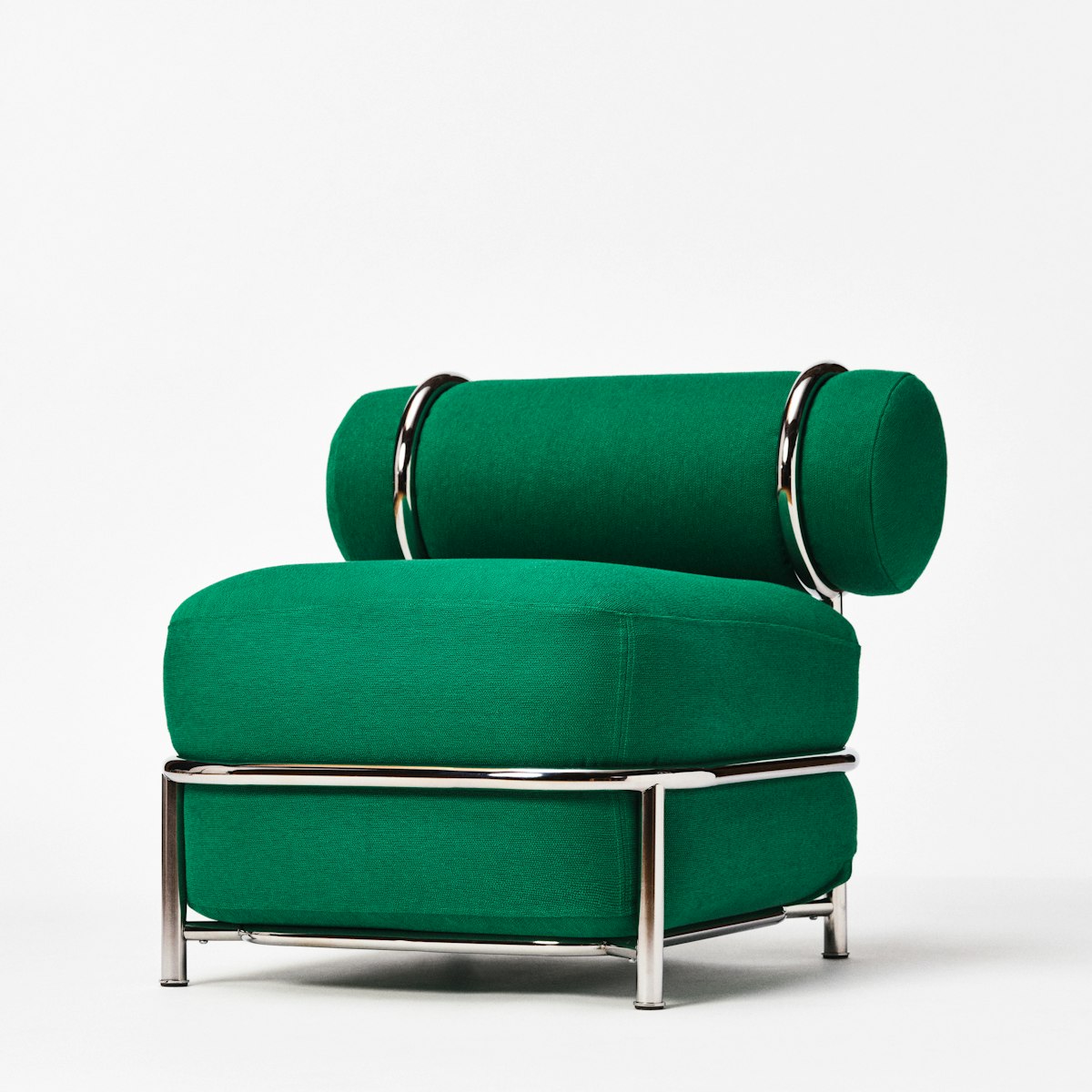 Front view of an air-filled green upholstered chair with a rounded back cushion and chrome frame, against a white background.