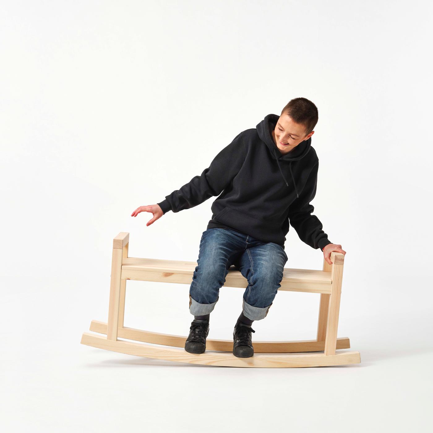 Designer Marta Krupińska rocks on the PS 2026 wooden rocking chair.