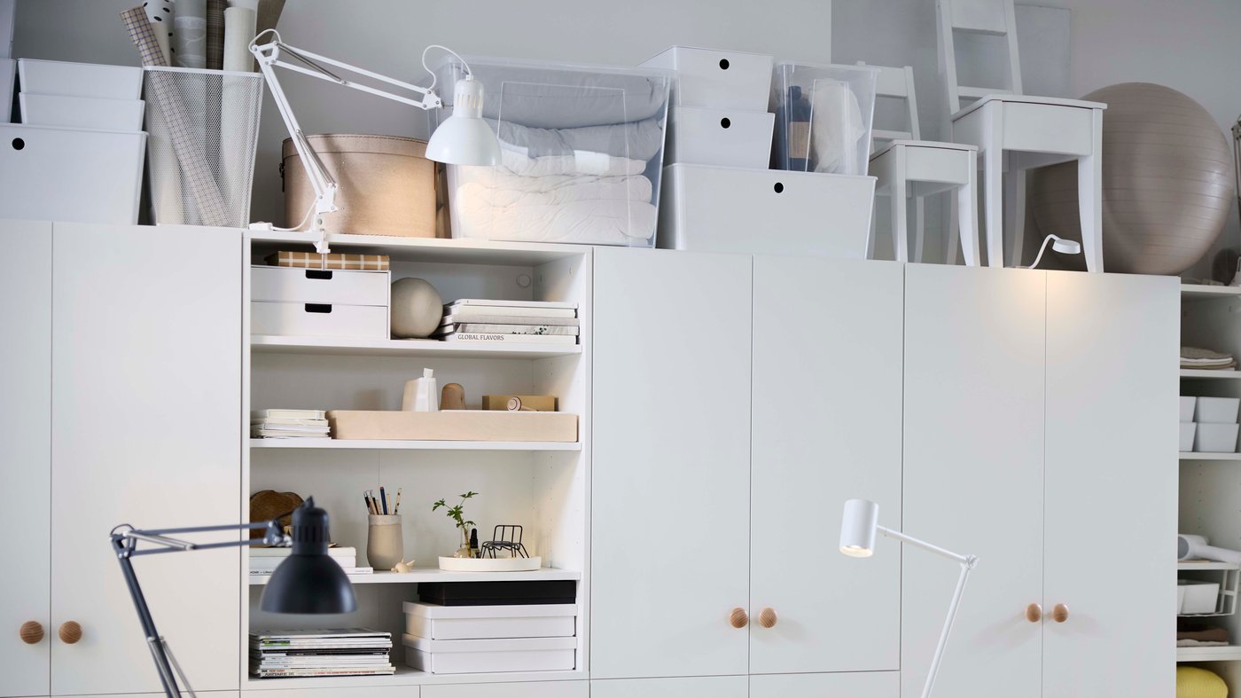 A white themed storage area with open and closed storage and white accessories.