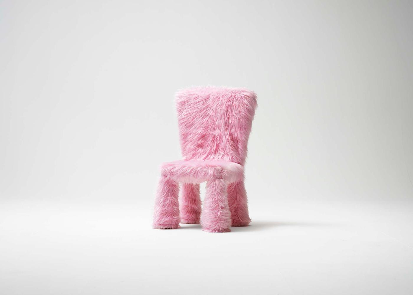 A pink fluffy chair in a white environment.