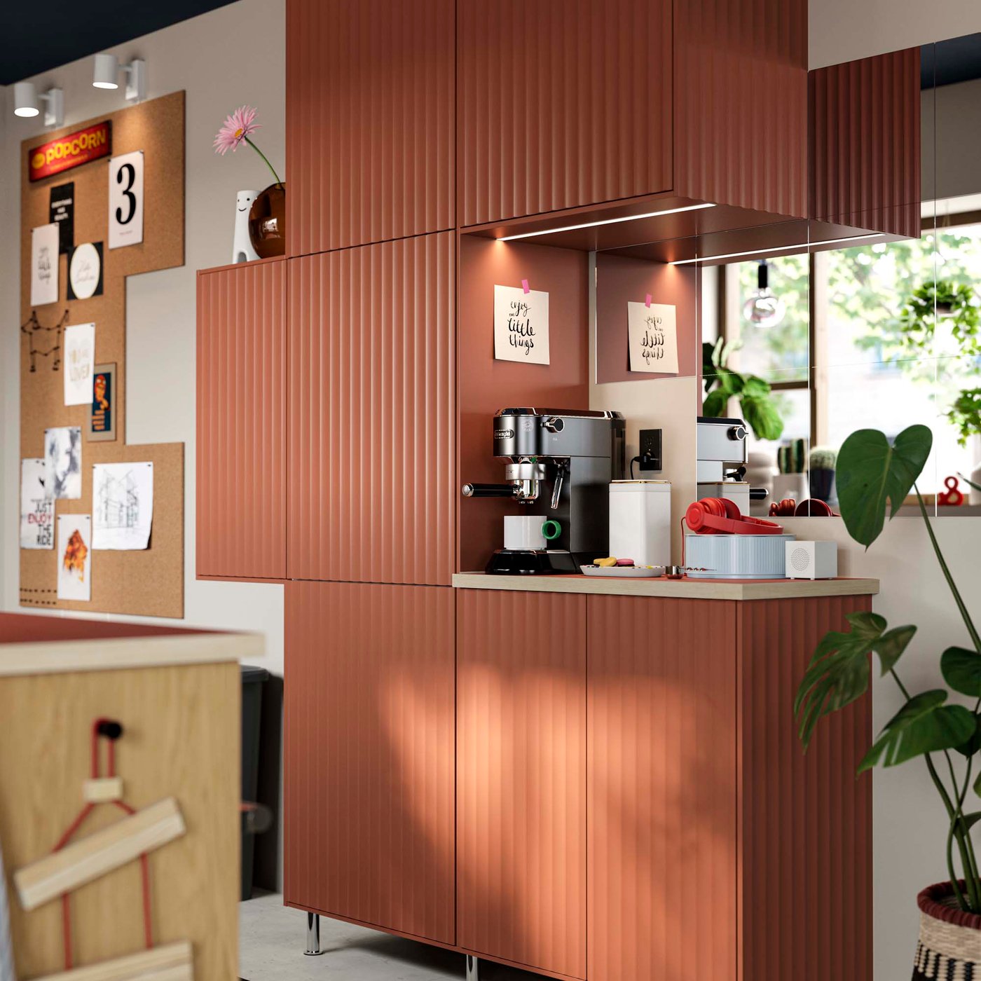Asymmetrically placed red-brown kitchen cabinets with a coffee station.