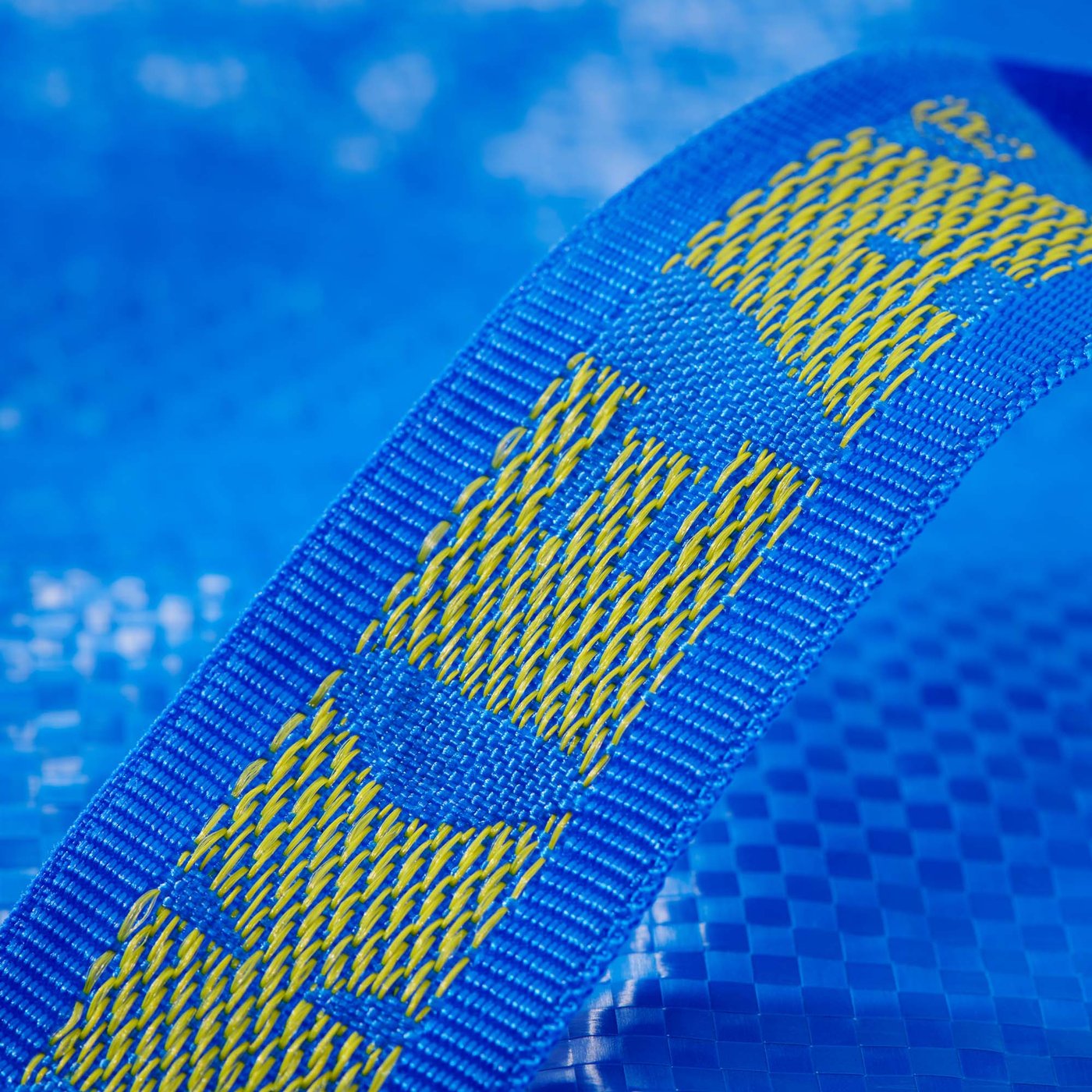 A close-up of the handle of a FRAKTA bag.