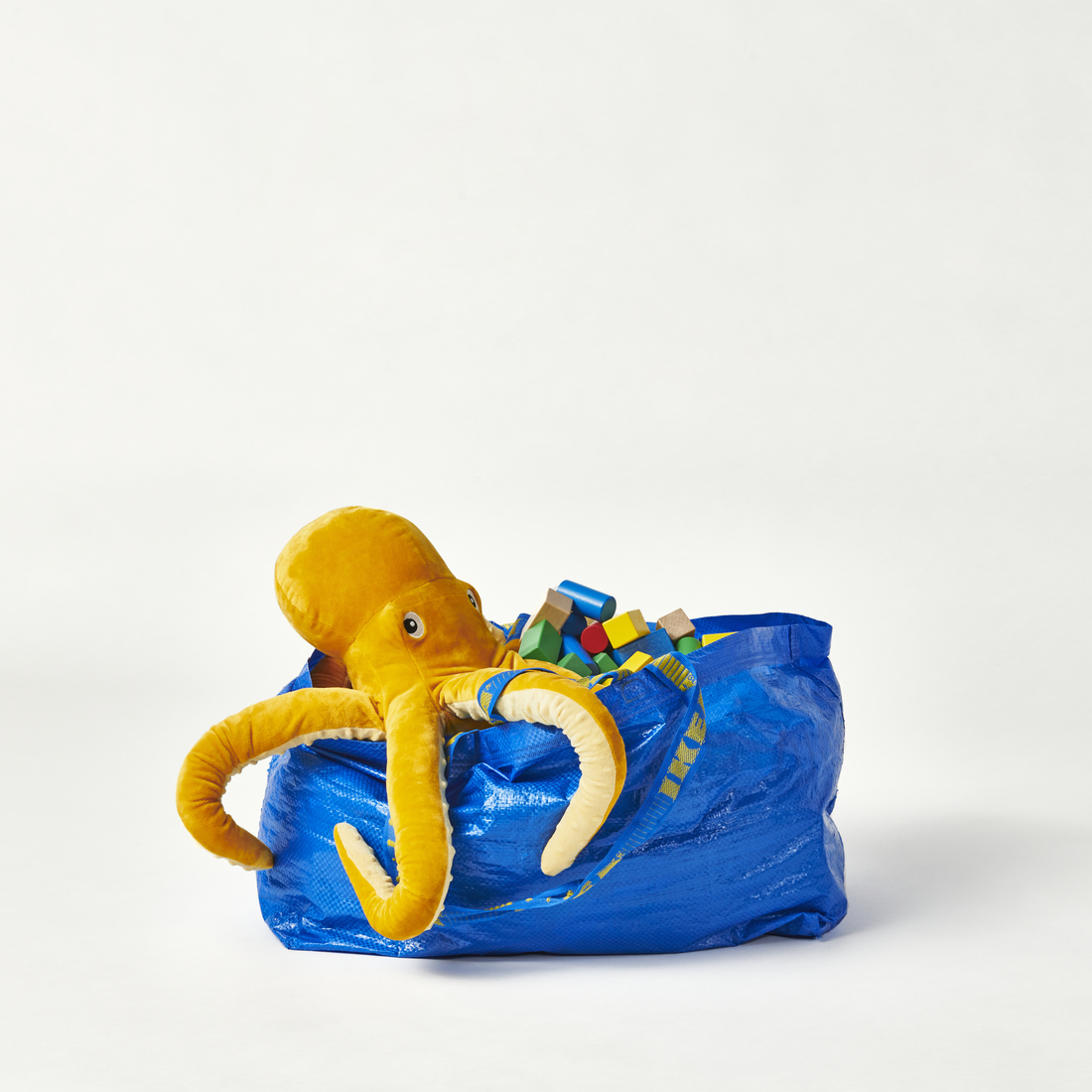 An updated FRAKTA bag carrying soft toys.