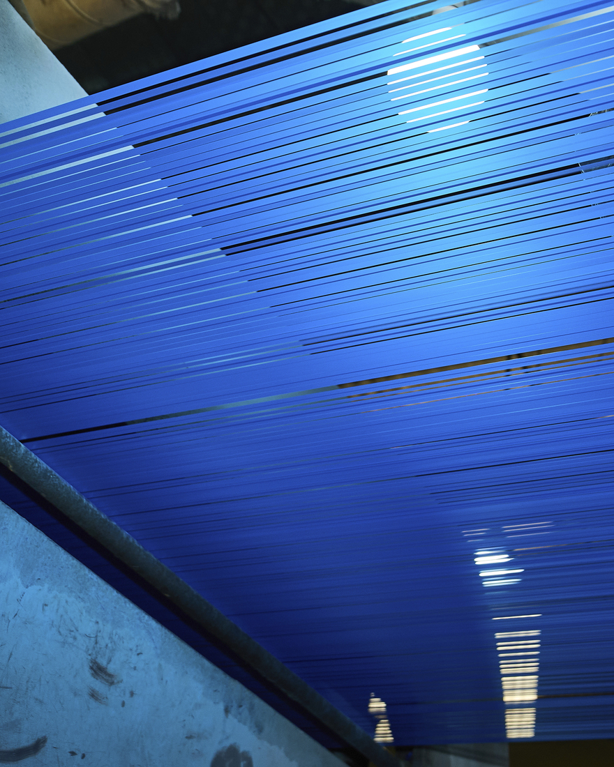 Blue thread made of recycled material is prepared to weave FRAKTA bags.