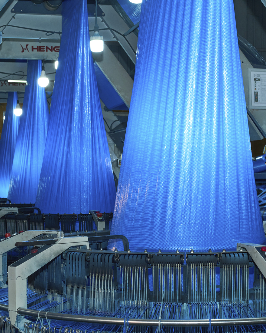 At the factory, blue recycled polypropylene sheets are transformed into thread.
