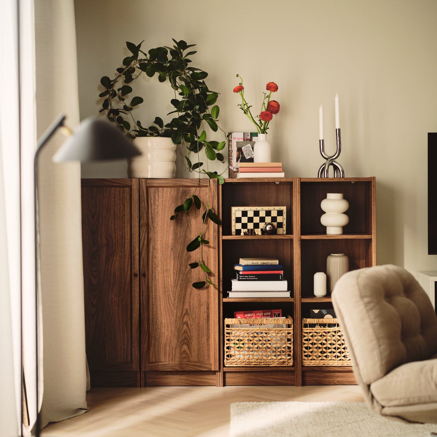 Corner of a warm, inviting living room with a BILLY bookcase bookcase in brown walnut effect.