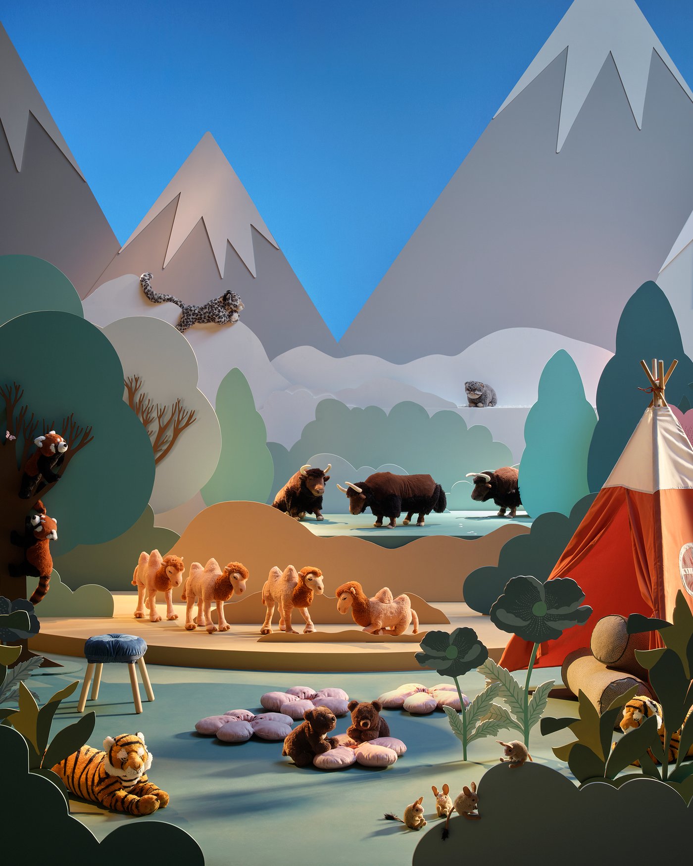 A backdrop of a Himalayan mountain scene with the ALPTALL collection of toy animals.