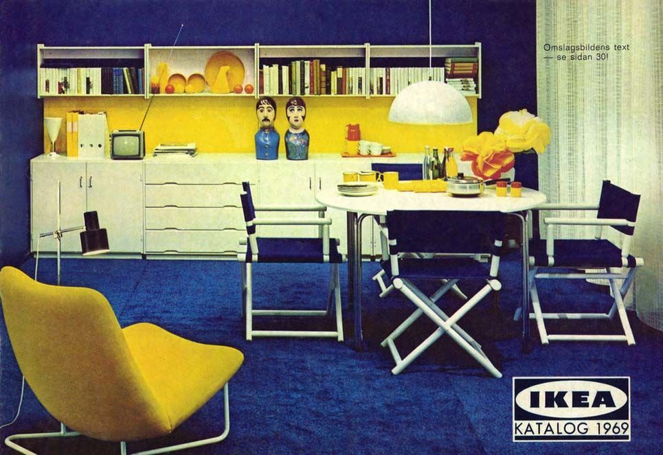 An image from the 1969 IKEA catalogue featuring a living/dining room area in blue, with a yellow chair, blue and white dining table and chairs and a white and yellow unit in the background.