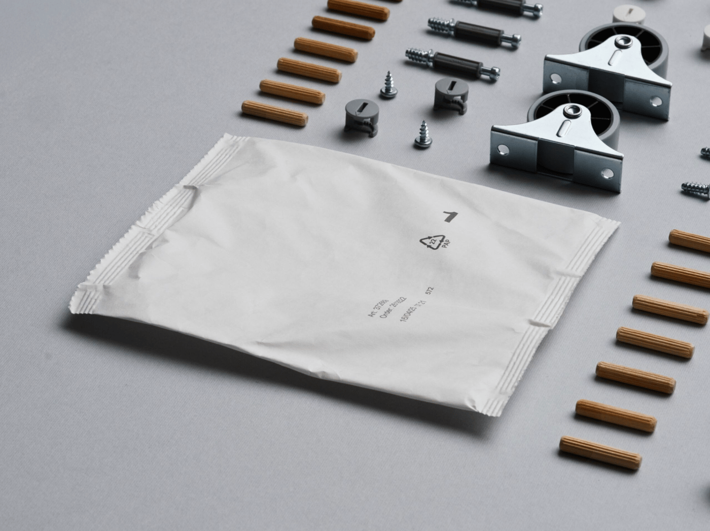 A paper-based bag next to neatly arranged IKEA assembly components.