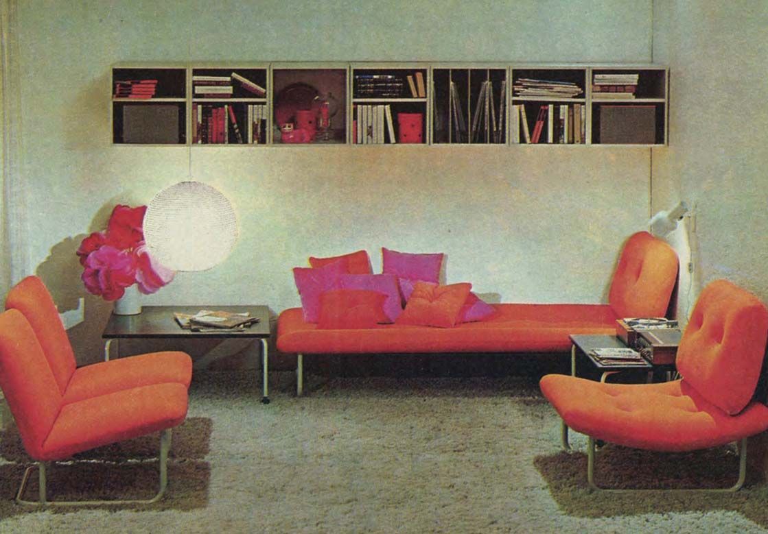 A vintage image from the 1970 IKEA catalogue featuring a red sofa and chairs with pink cushions, and a white RISLAMPA pendant lamp hanging from the ceiling.