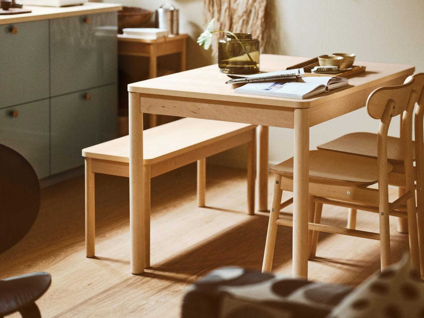 RÖNNINGE table and two RÖNNINGE chairs together with a wooden bench in a kitchen dining area.