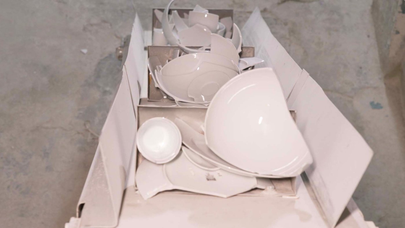 Broken ceramics on a conveyor belt.