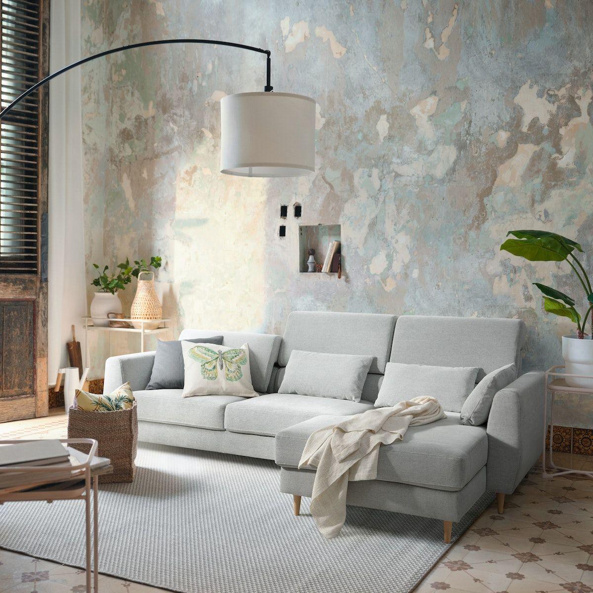 A pale blue SLATORP sofa in a living room. There is a lamp in the forefront.